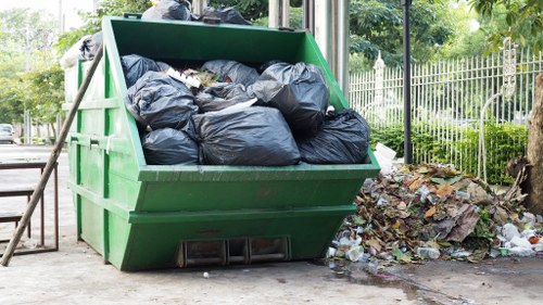 Workers efficiently clearing builders waste in Forestgate